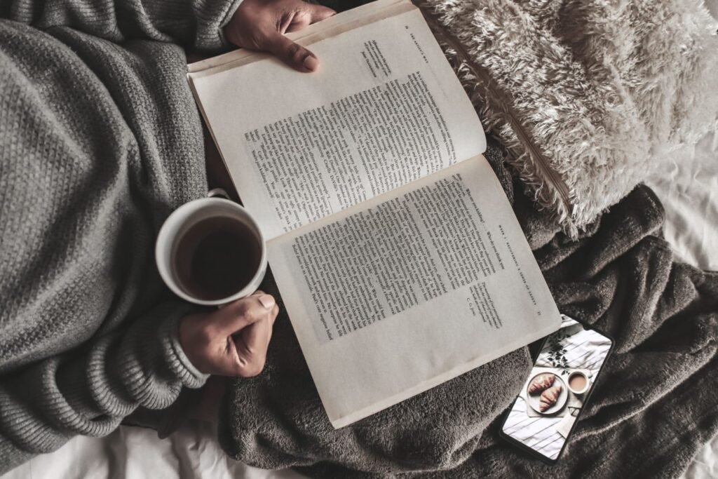 Reading novels with a cup of coffee in a cozy setting, showcasing the joy and benefits of reading books